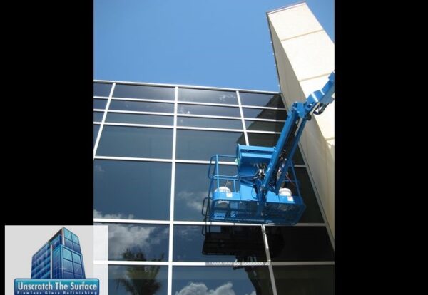 hard water stain removal our Glass scratch removal on tall hurricane glass curtain wall from JLG boom lift. Scratches visible towards top. Restoration project in Biloxi, MS